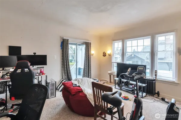 a view of a bedroom with workspace and windows