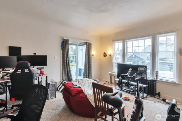 a view of a bedroom with workspace and windows