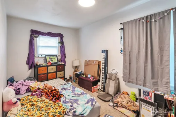 a bedroom with bed and a window