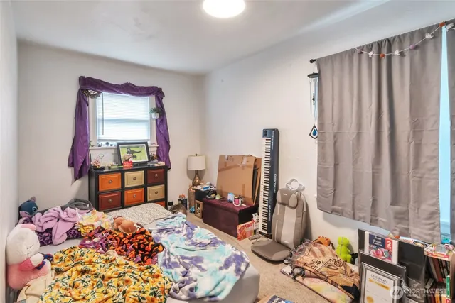 a bedroom with bed and a window