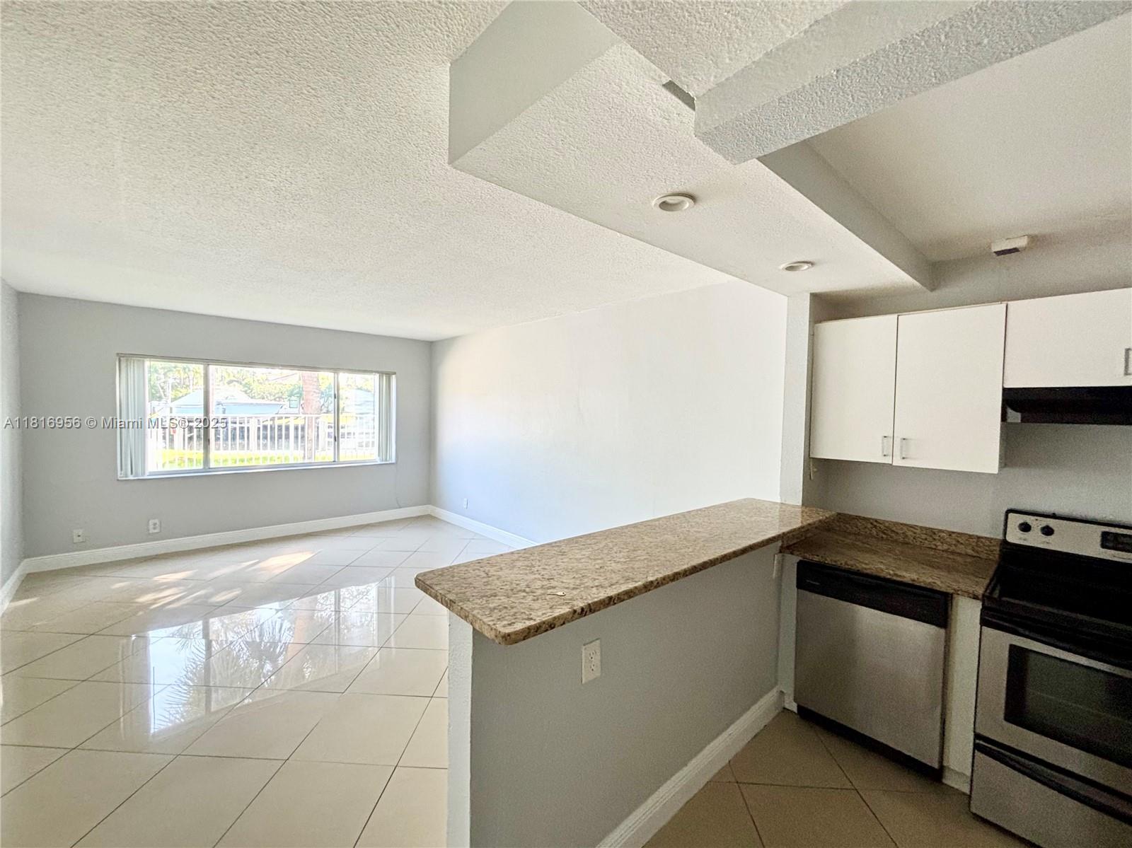 a kitchen that has a sink and a stove