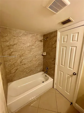 a bathroom with bathtub and shower
