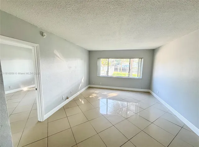 a view of an empty room and window