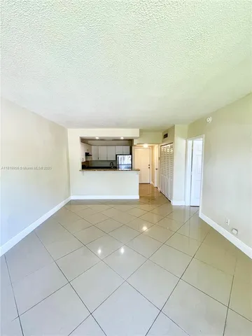 a view of a livingroom with kitchen and furniture