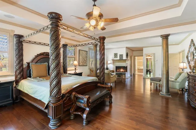 a kitchen with granite countertop stainless steel appliances wooden floor dining table and chairs