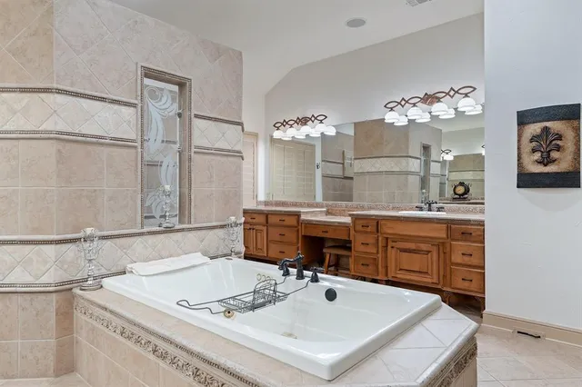 a bathroom with a tub sink and mirror