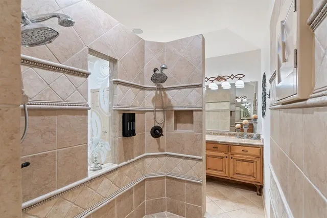 a spacious bathroom with a sink a large mirror and a bathtub