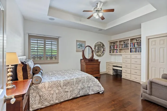a bathroom with a toilet a sink a mirror a vanity and shower