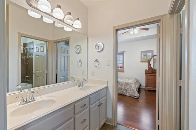 a bedroom with furniture and a large window