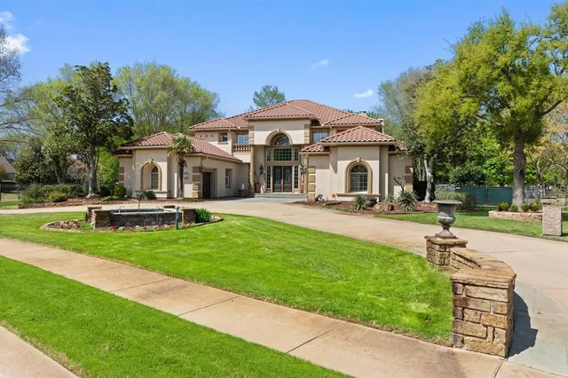 a front view of a house with a yard table and chairs