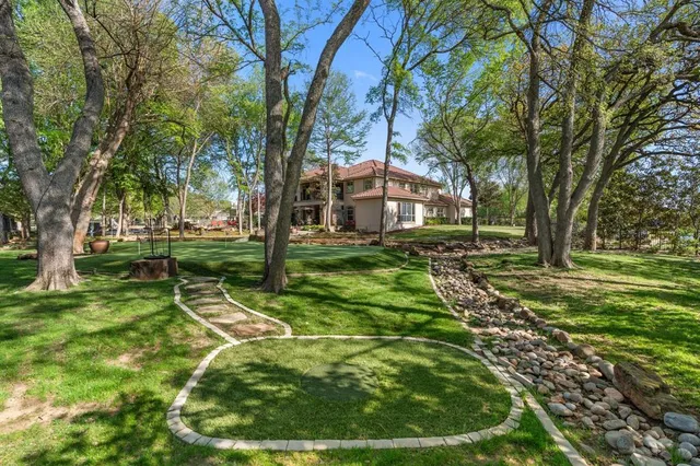 a front view of a house with yard and green space
