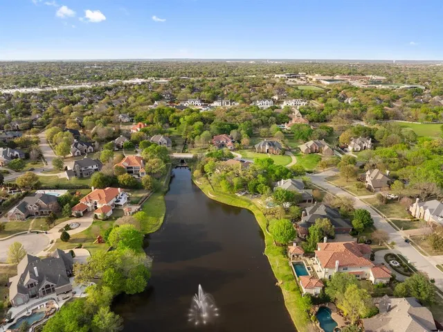 an aerial view of a house with a garden and a yard