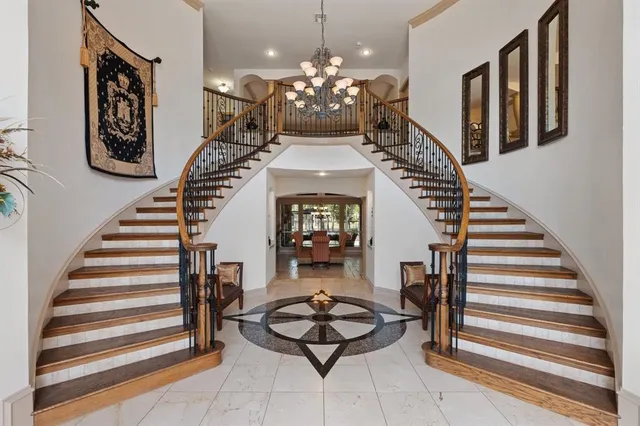 a lobby with furniture and a chandelier