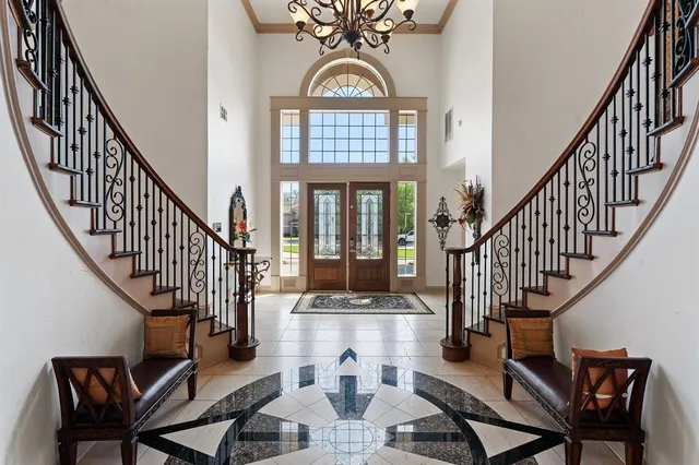 a view of a hall with dining room and wooden floor