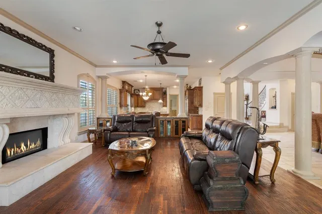 a living room with furniture a fireplace and wooden floor