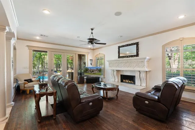 a living room with furniture fireplace and a large window