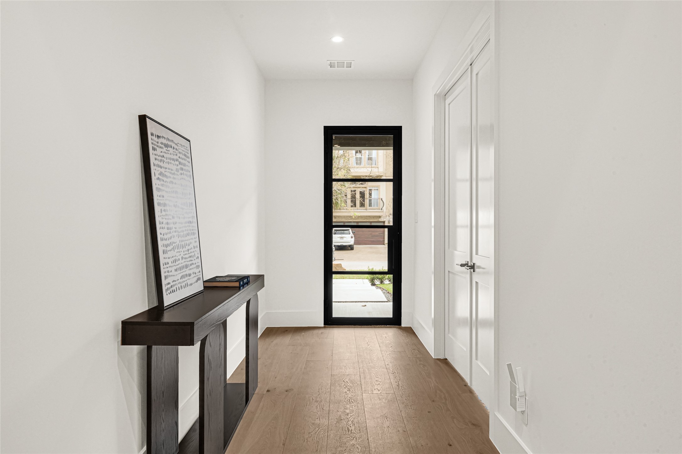 6405 Rodrigo Street, Unit A Houston, TX 77007 - Photo 3 of 28 a view of a hallway with wooden floor and closet