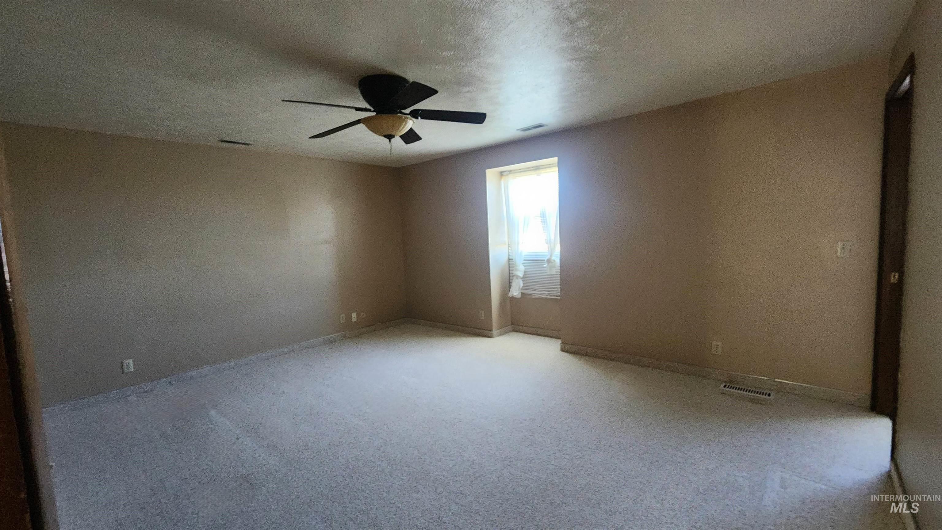 288 South 123 West Burley, ID 83318 - Photo 18 of 36 Unfurnished room with a textured ceiling, carpet floors, and a ceiling fan
