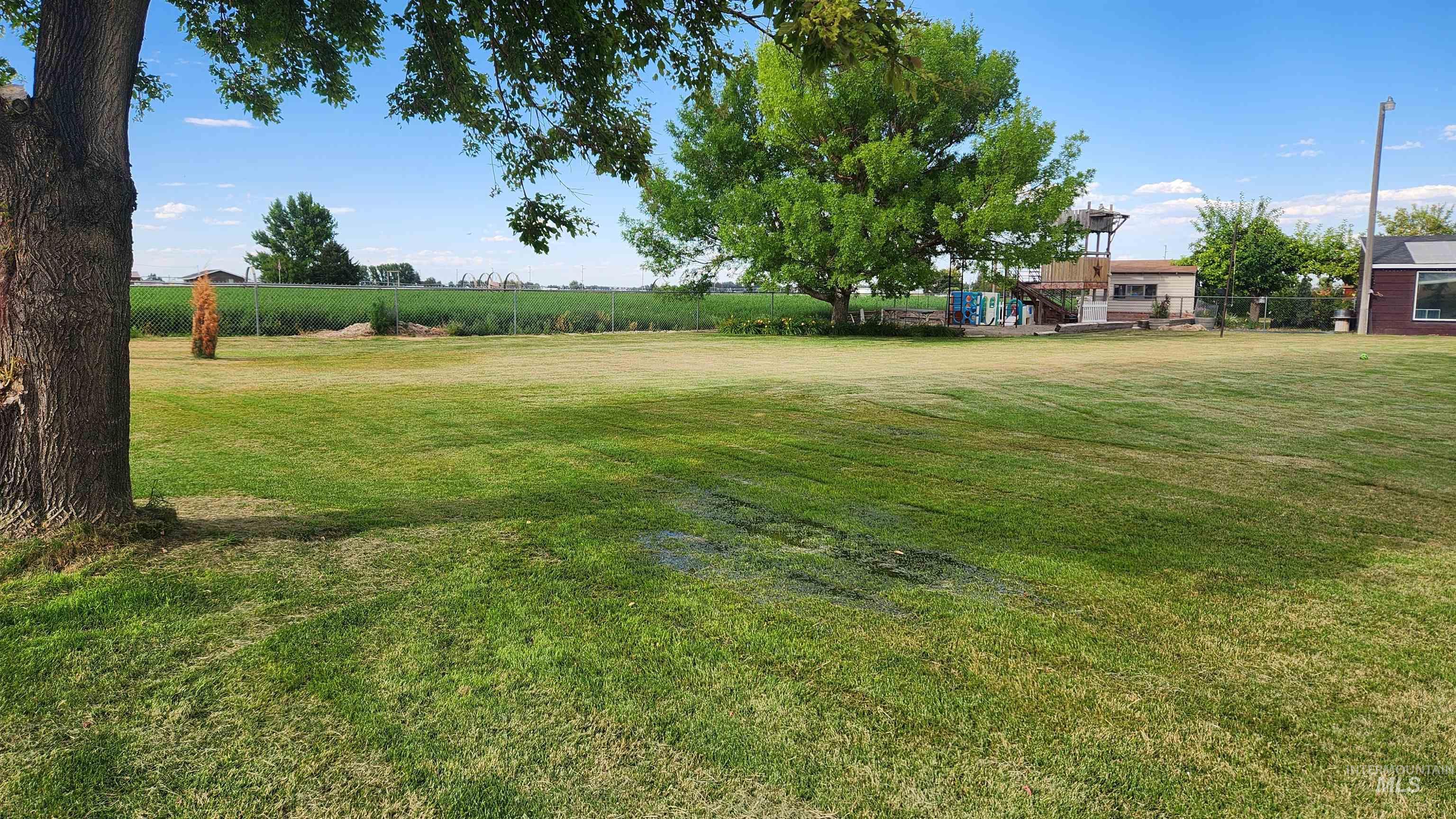 288 South 123 West Burley, ID 83318 - Photo 2 of 36 View of grassy yard with a deck
