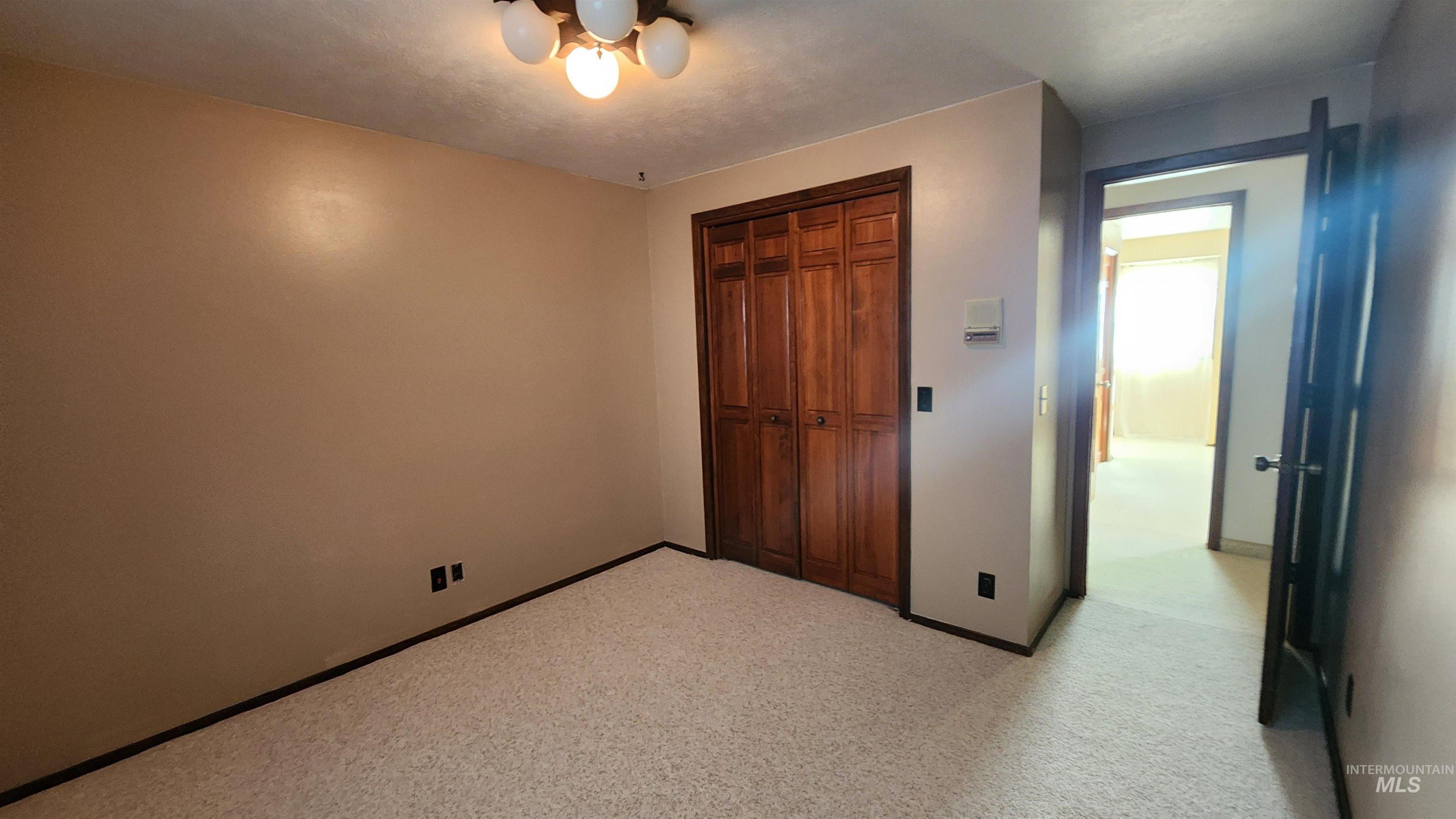 288 South 123 West Burley, ID 83318 - Photo 26 of 36 Bedroom with a closet with built in storage shelves and light colored carpet