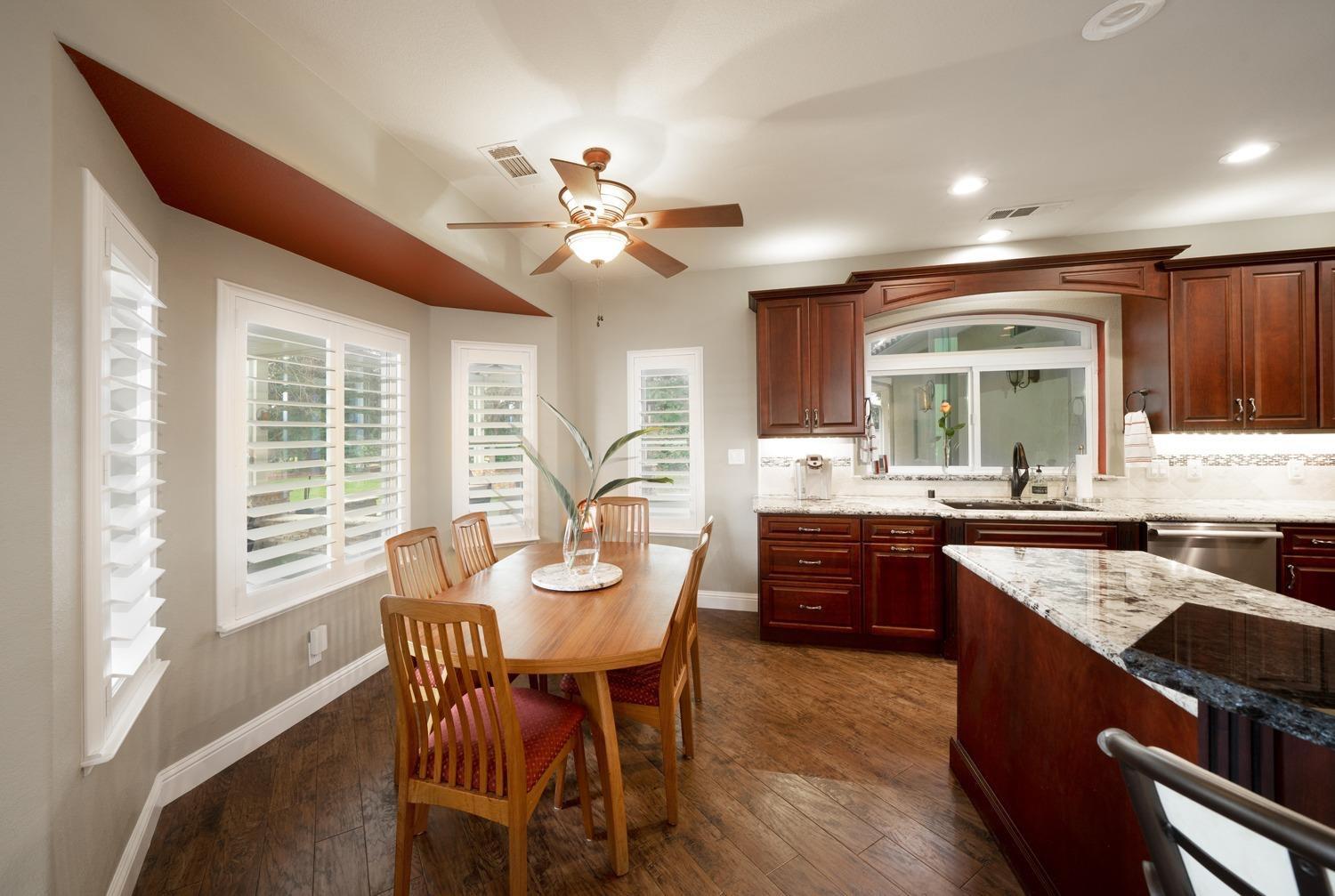 1290 North Applegate Avenue Fresno, CA 93737 - Photo 12 of 65 a kitchen with a table chairs sink and cabinets