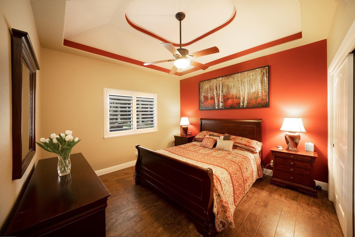 1290 North Applegate Avenue Fresno, CA 93737 - Photo 17 of 65 a bed sitting in a bedroom next to a window
