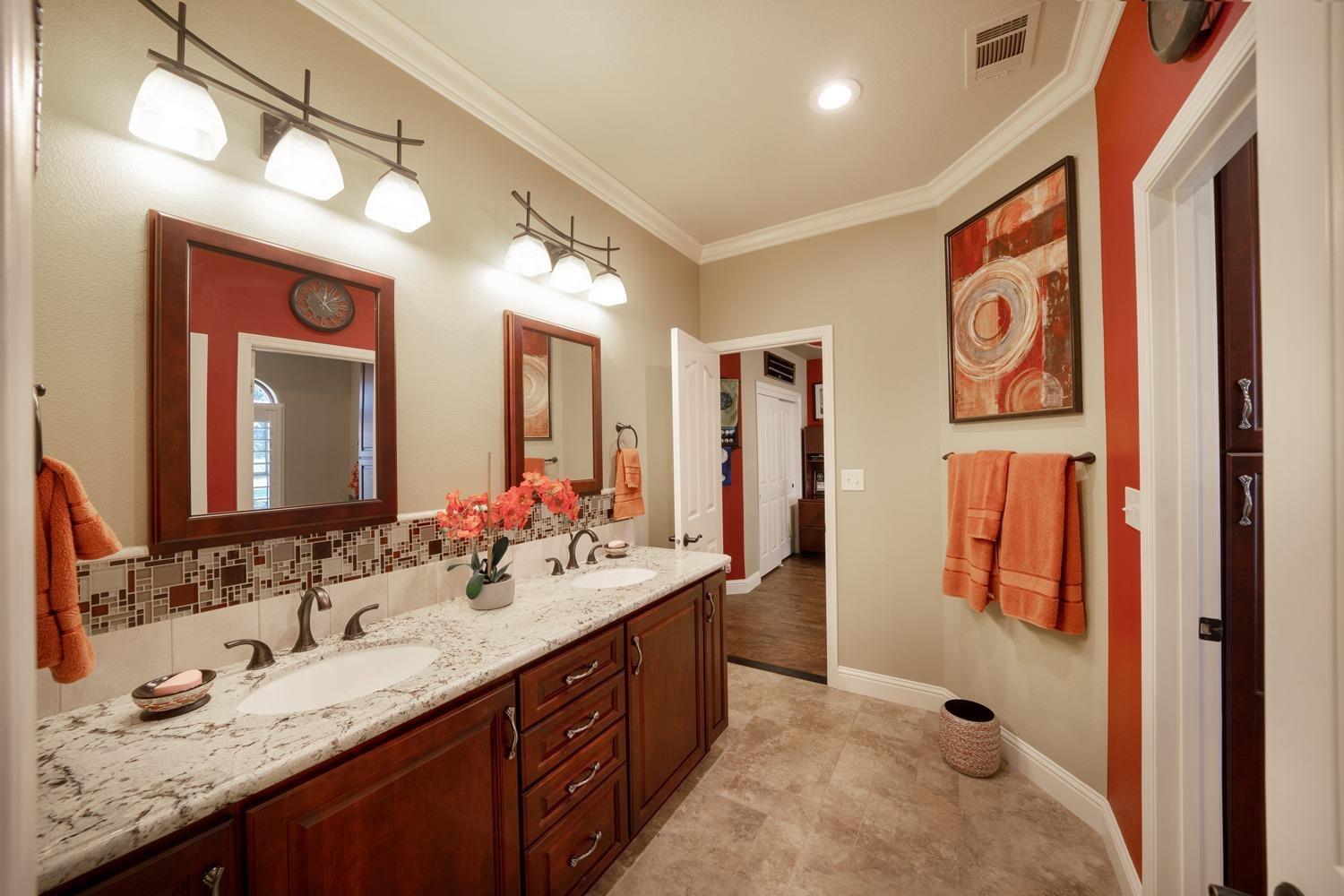 1290 North Applegate Avenue Fresno, CA 93737 - Photo 20 of 65 a spacious bathroom with a granite countertop sink and a mirror