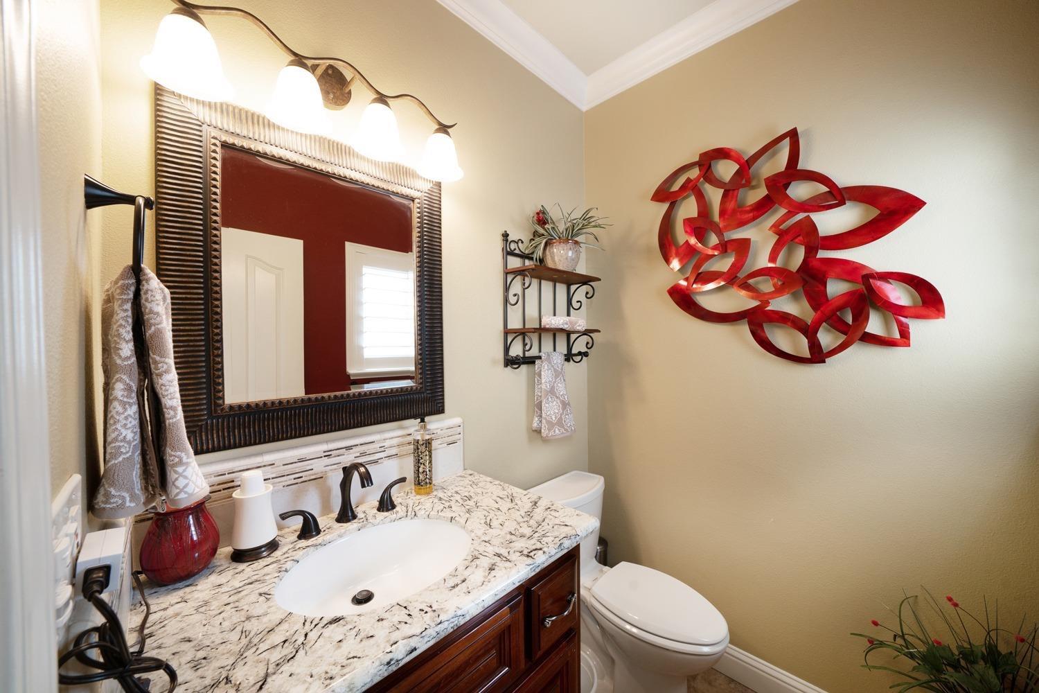 1290 North Applegate Avenue Fresno, CA 93737 - Photo 23 of 65 a bathroom with a granite countertop sink and a mirror