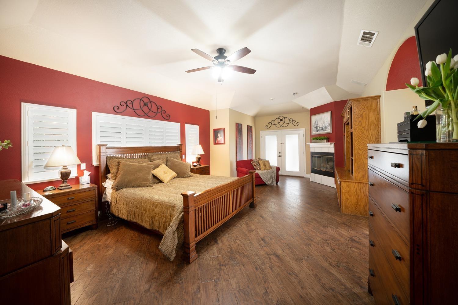 1290 North Applegate Avenue Fresno, CA 93737 - Photo 24 of 65 a spacious bedroom with a large bed and a chandelier