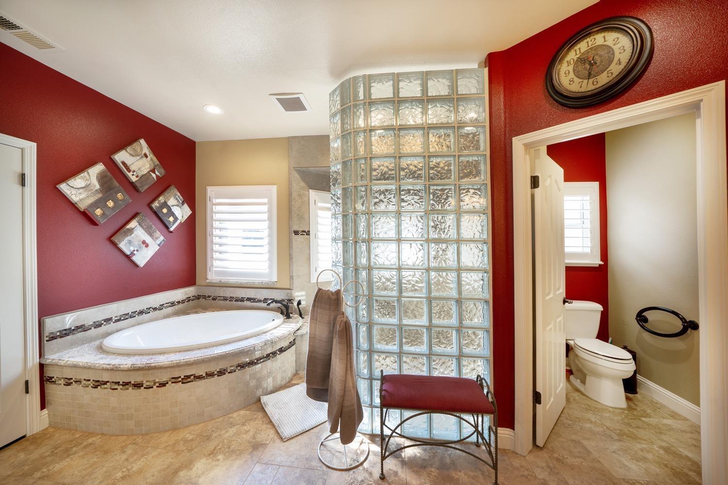 1290 North Applegate Avenue Fresno, CA 93737 - Photo 26 of 65 a bathroom with a toilet a sink and a mirror