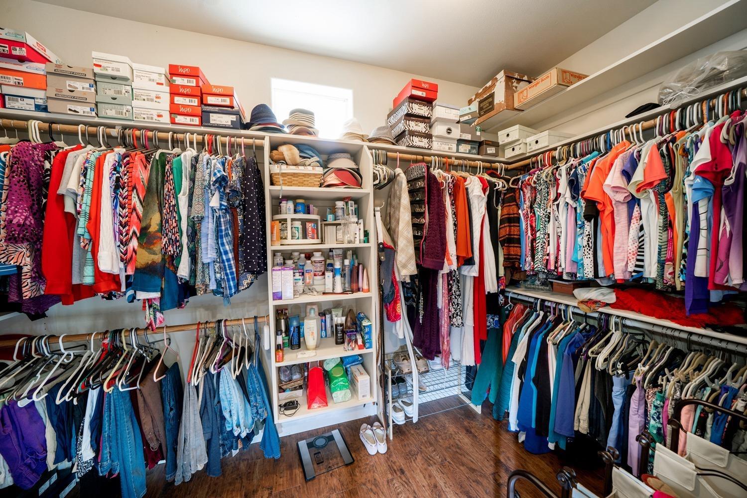 1290 North Applegate Avenue Fresno, CA 93737 - Photo 28 of 65 a view of walk in closet with clothes and shoes