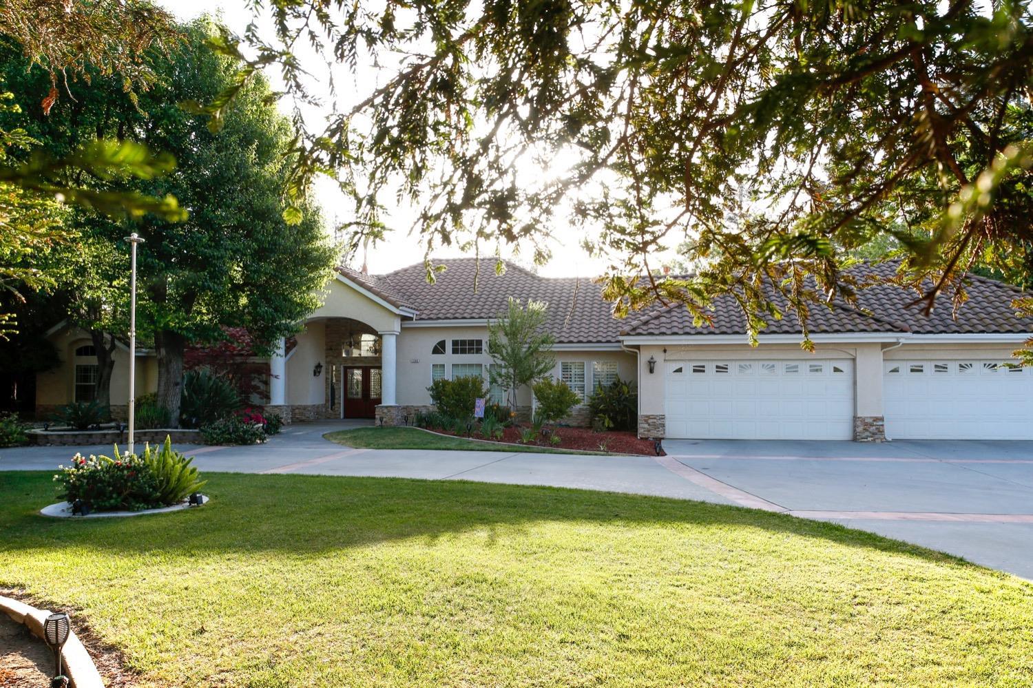 1290 North Applegate Avenue Fresno, CA 93737 - Photo 3 of 65 a view of house with yard outdoor seating and swimming pool