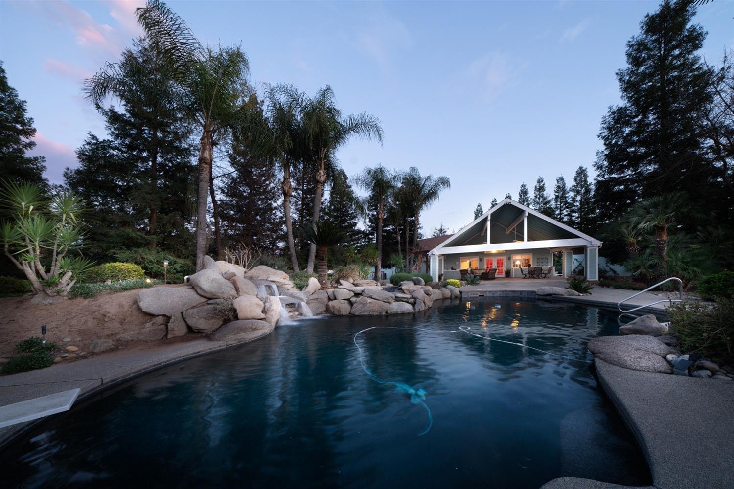 1290 North Applegate Avenue Fresno, CA 93737 - Photo 42 of 65 a view of swimming pool with lawn chairs and plants