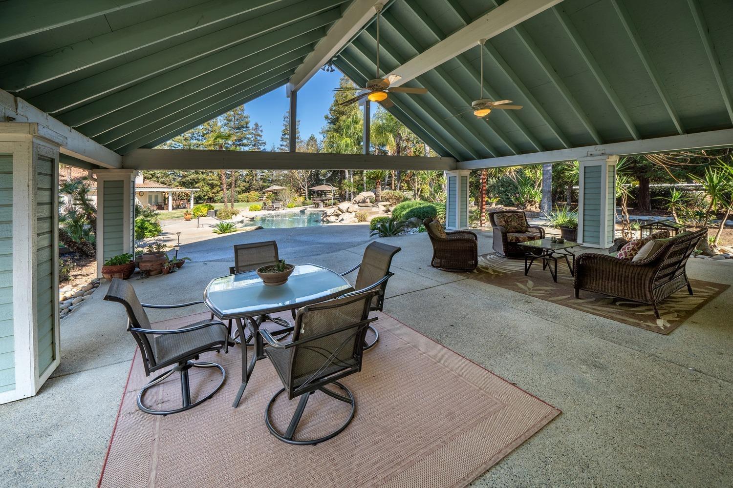 1290 North Applegate Avenue Fresno, CA 93737 - Photo 43 of 65 a dining room with furniture and a floor to ceiling window