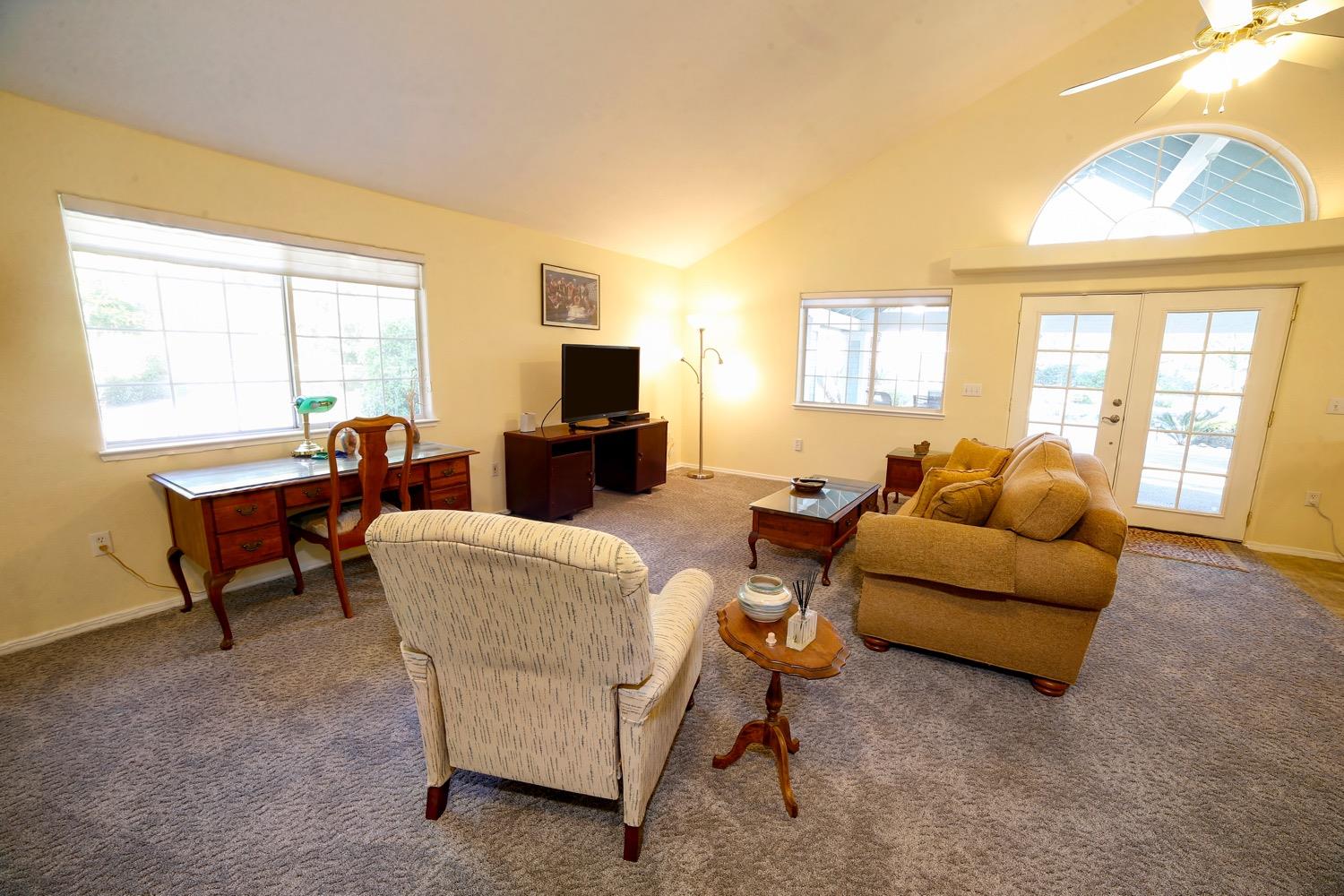 1290 North Applegate Avenue Fresno, CA 93737 - Photo 62 of 65 a living room with furniture and a flat screen tv