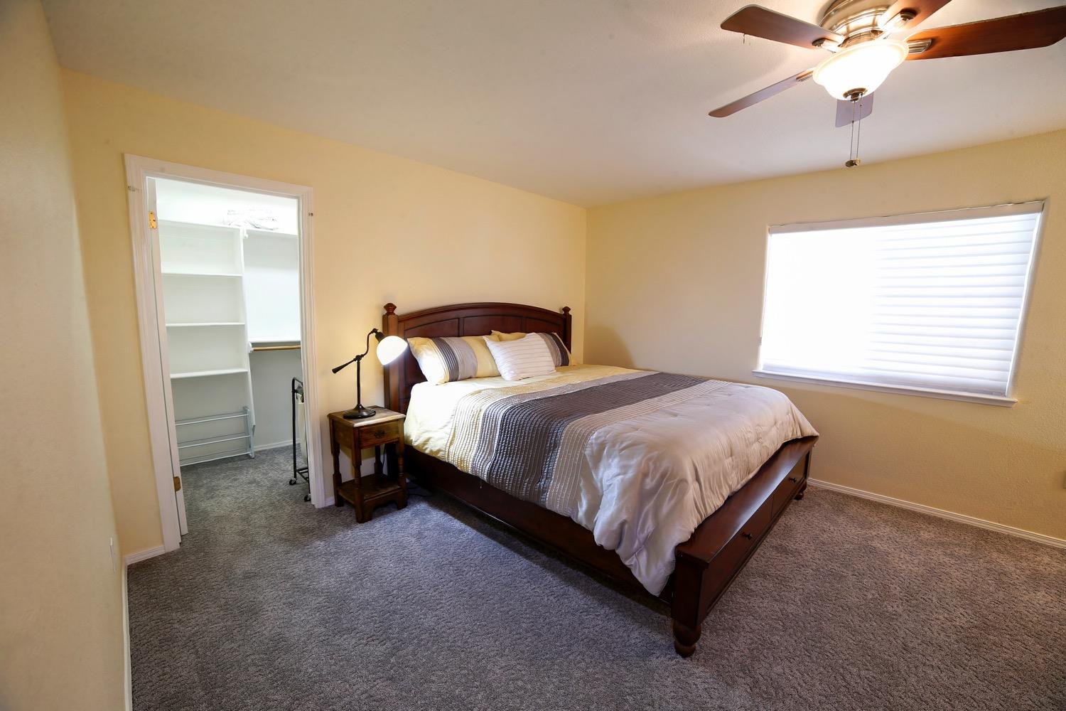 1290 North Applegate Avenue Fresno, CA 93737 - Photo 63 of 65 a bedroom with a bed and window