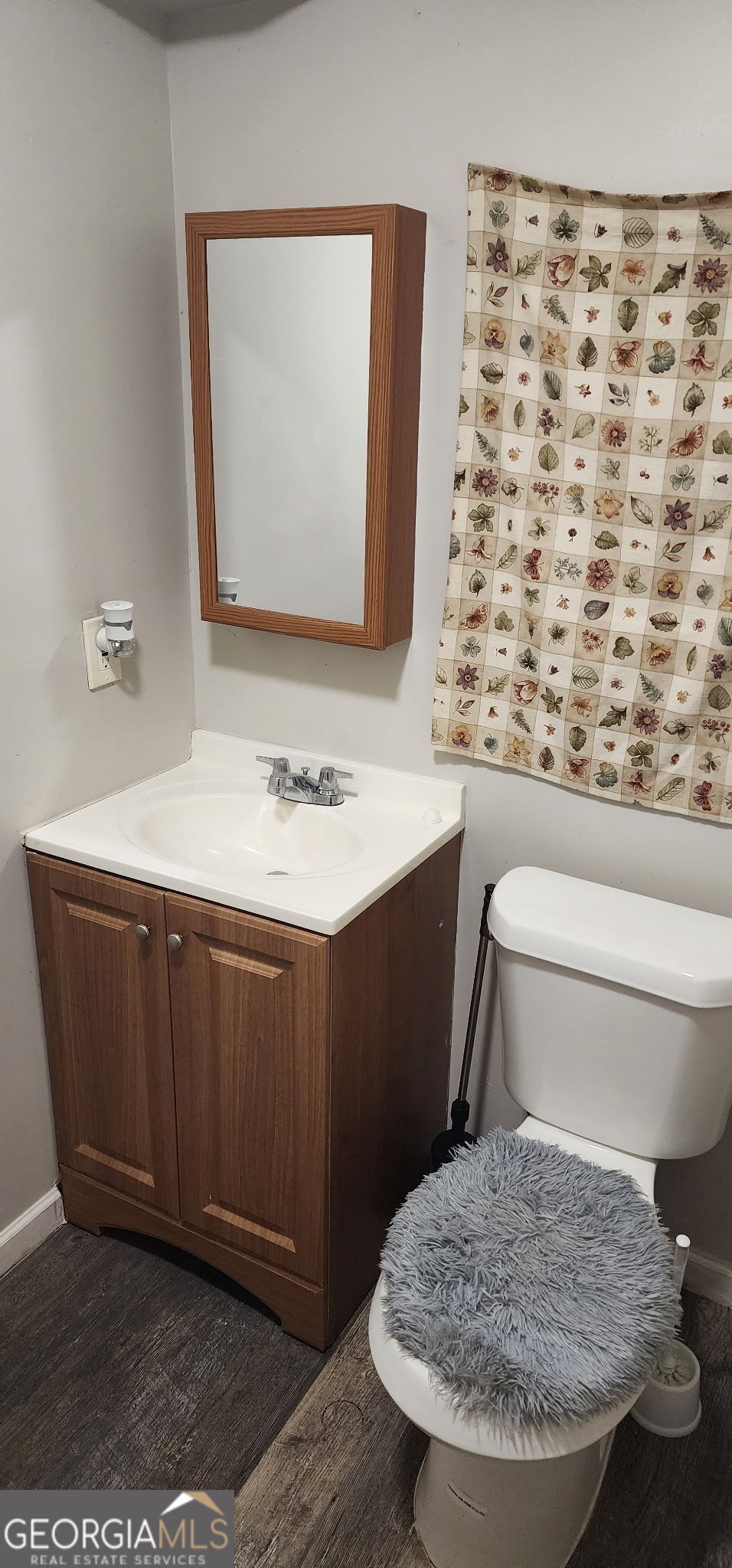 4778 Devon Way Stone Mountain, GA 30088 - Photo 4 of 4 a bathroom with a sink toilet and mirror