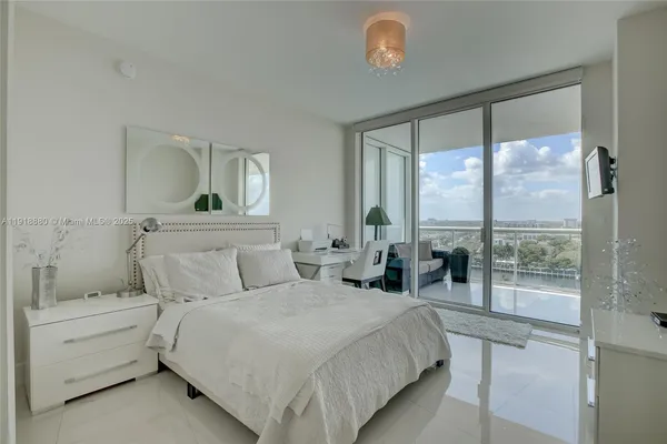 a bedroom with a large bed and a large window