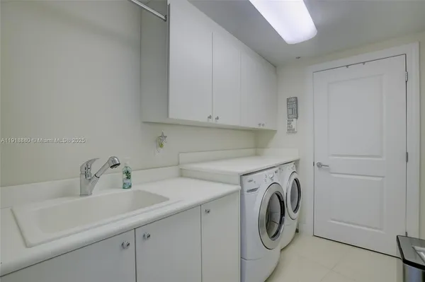 a utility room with sink dryer and washer