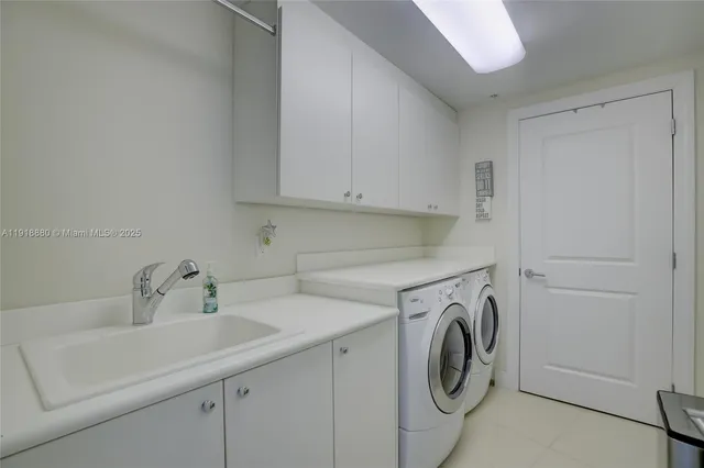 a utility room with sink dryer and washer