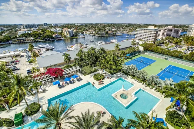 a living room with furniture a large window and a chandelier