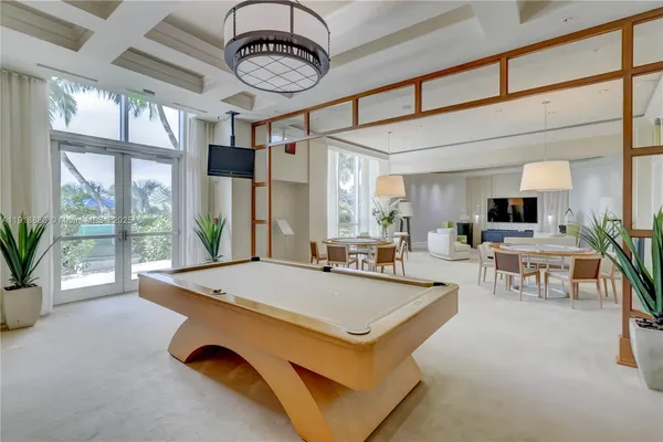 a living room with furniture and large windows