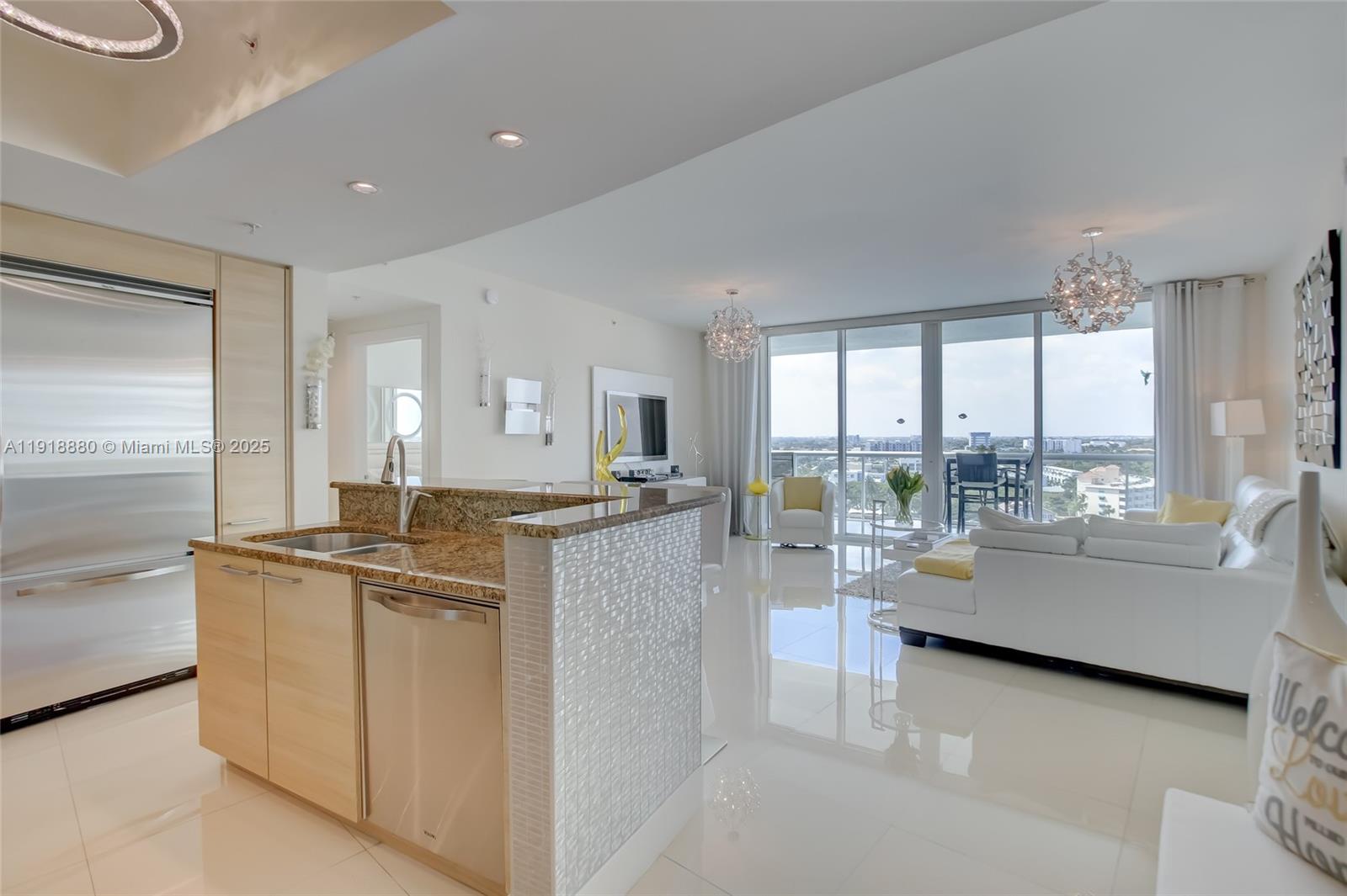 1 North Ocean Boulevard, Unit 1011 Pompano Beach, FL 33062 - Photo 4 of 48 a room with kitchen island granite countertop a large window and a view of living room
