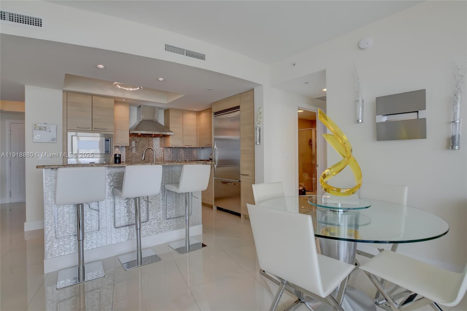 1 North Ocean Boulevard, Unit 1011 Pompano Beach, FL 33062 - Photo 9 of 48 a living room with furniture a rug and kitchen view