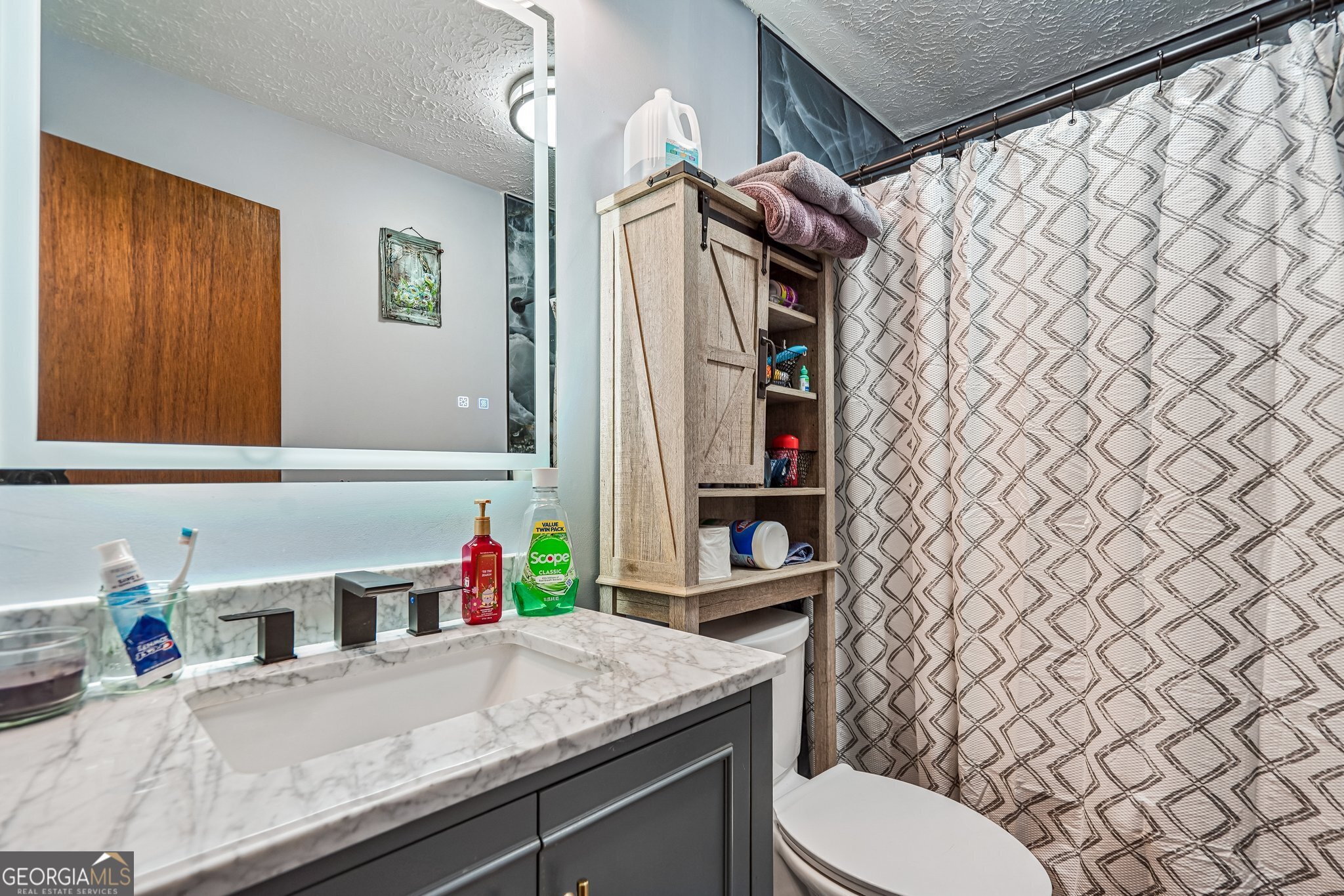 241 Busbin Road Fayetteville, GA 30215 - Photo 25 of 45 a bathroom with a granite countertop sink and a toilet