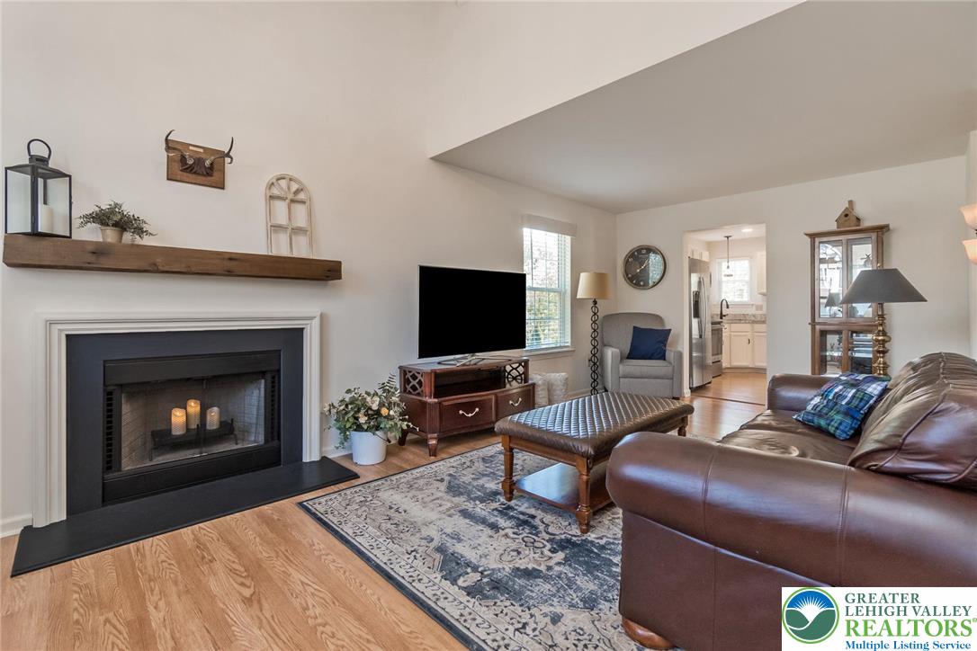 2314 Red Maple Drive Coplay, PA 18037 - Photo 8 of 73 A welcoming living area with a cozy fireplace and vaulted ceiling, perfect for relaxation.