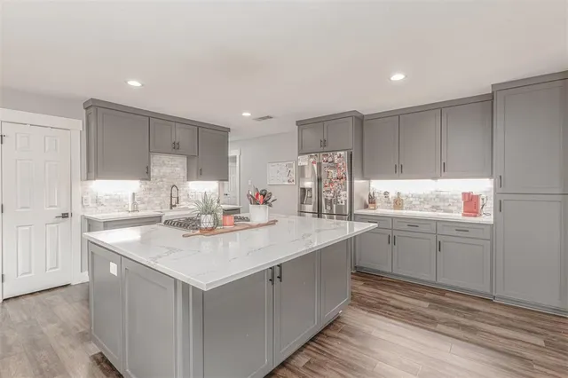 a kitchen with a sink stove and cabinets