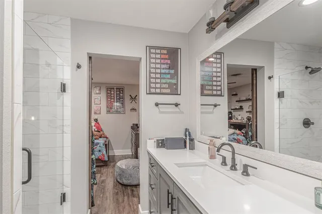 a bathroom with a sink double vanity and a shower
