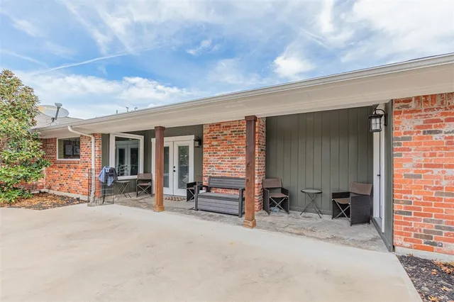 a view of living room filled with furniture and large windows