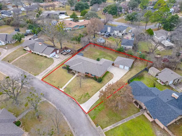 an aerial view of a house with a swimming pool